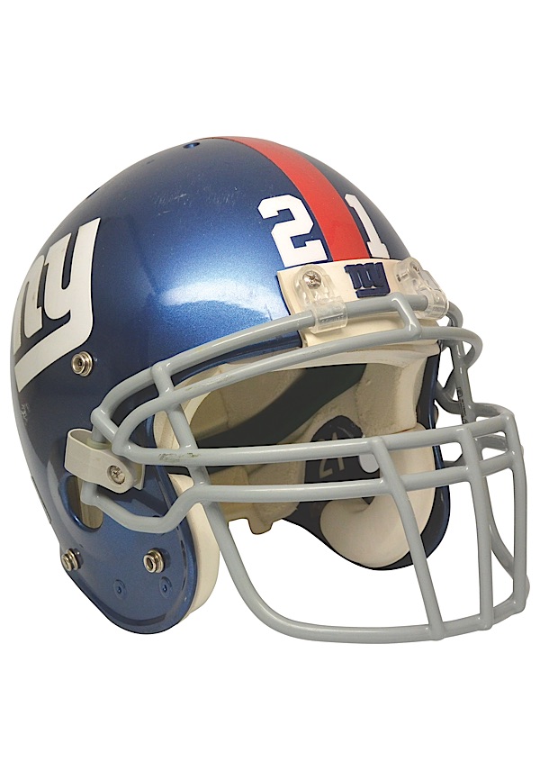 New York Giants Tiki Barber grabs his helmet as he walks off of